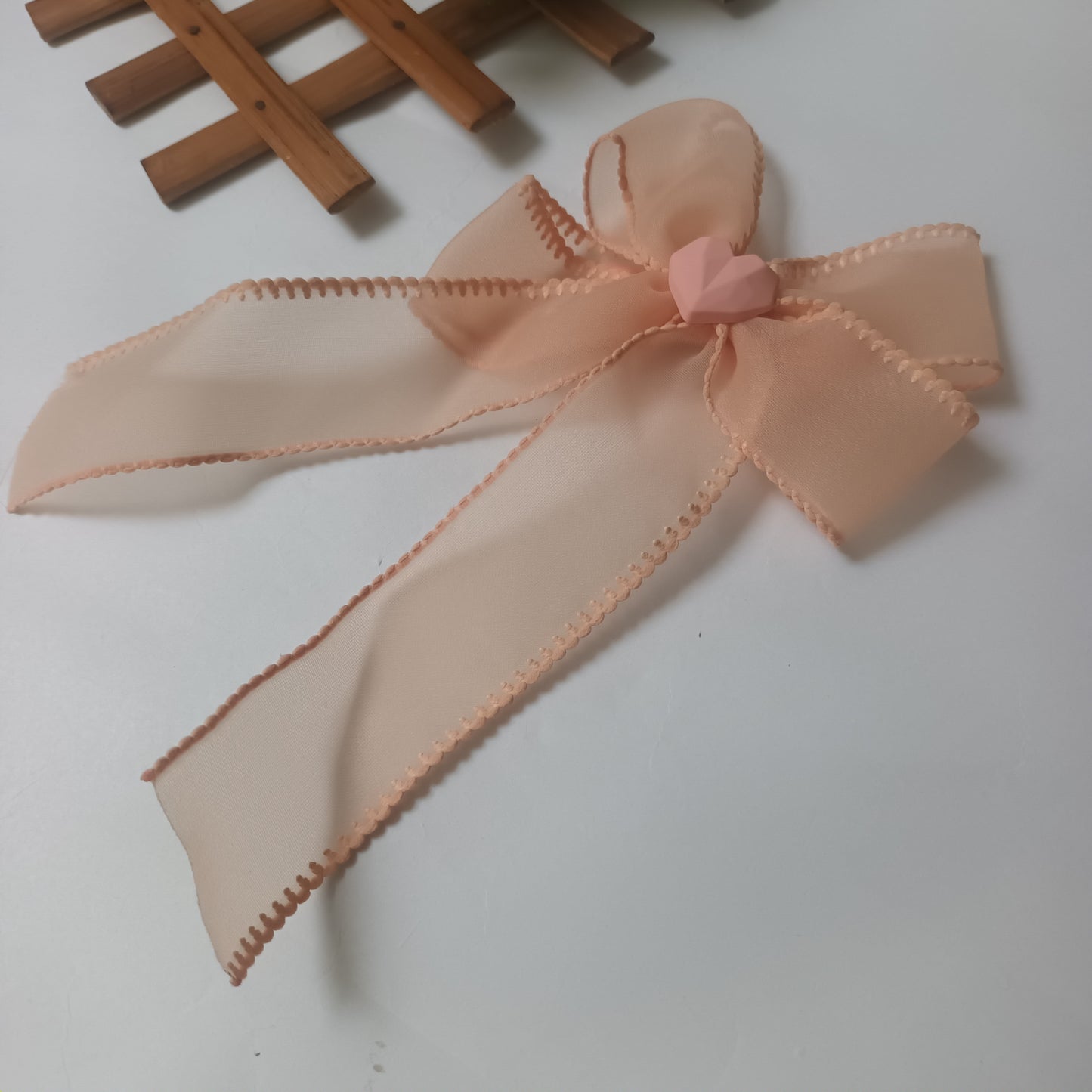 Alvina peach organza bow aligator pin