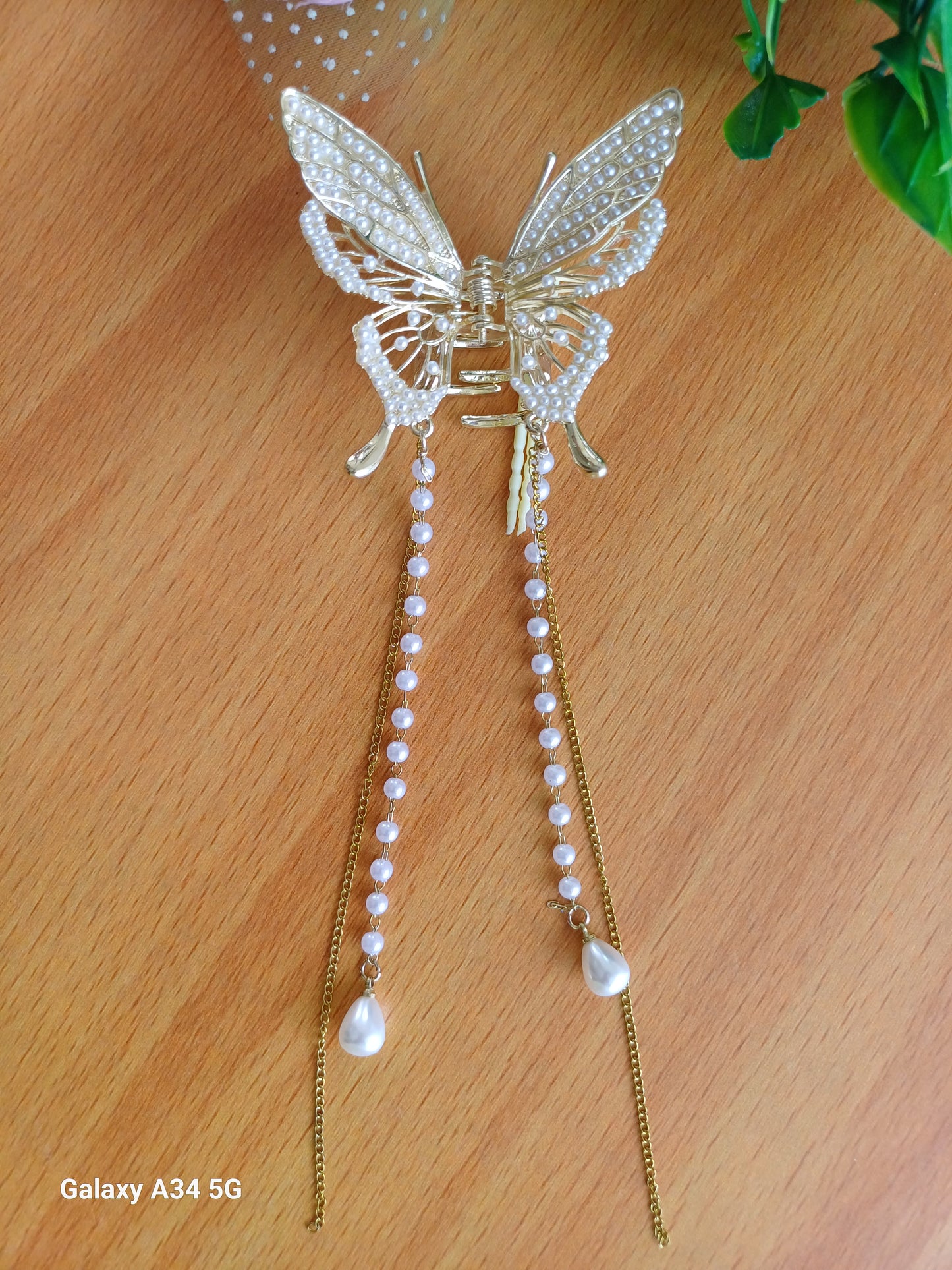 Shaila pearl butterfly tasseled claw