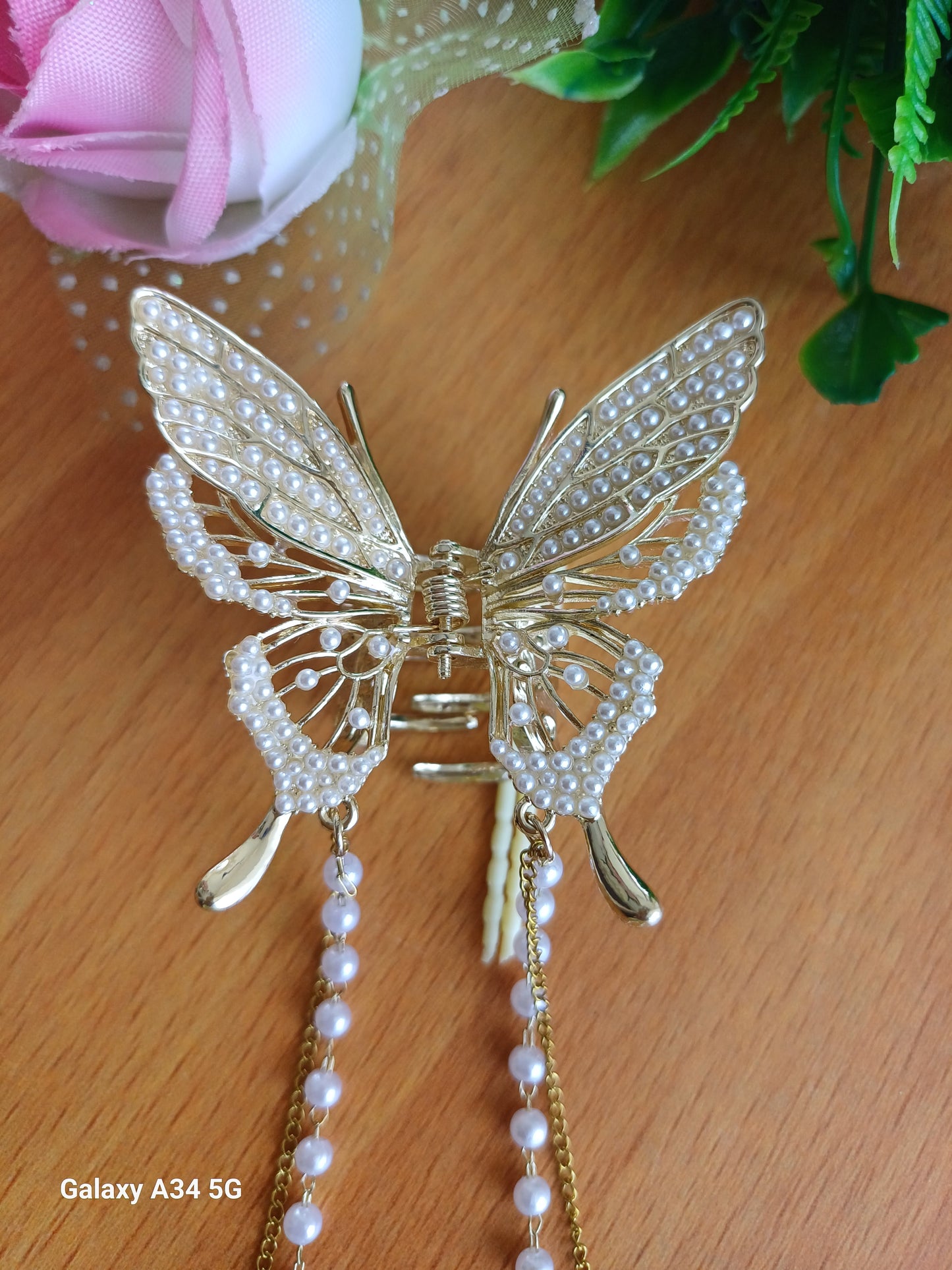 Shaila pearl butterfly tasseled claw