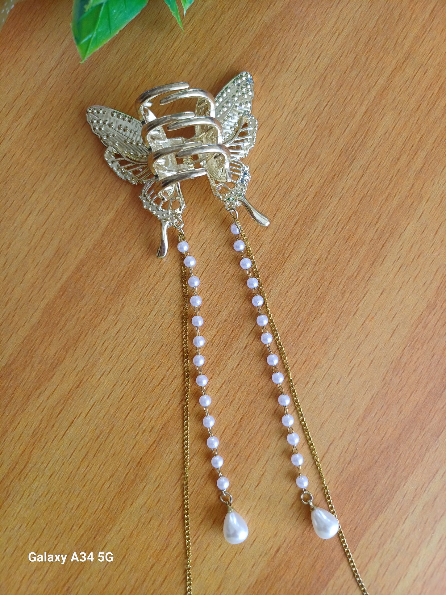 Shaila pearl butterfly tasseled claw